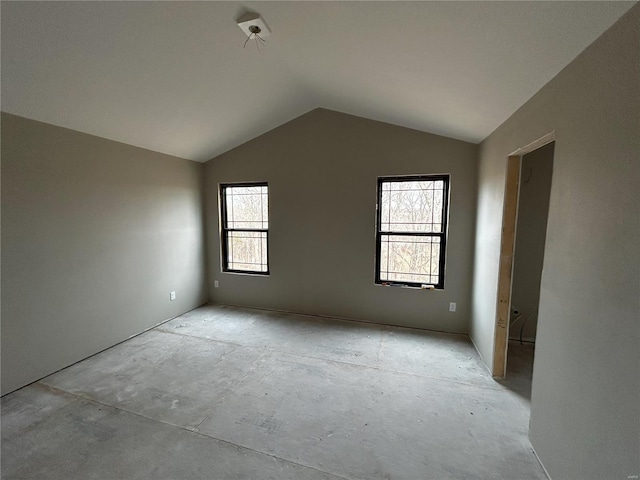 empty room with a healthy amount of sunlight and lofted ceiling