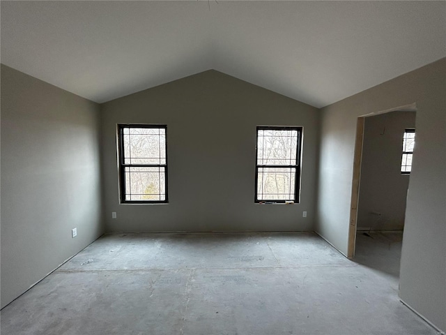 spare room featuring vaulted ceiling