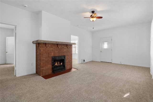 unfurnished living room featuring ceiling fan, light carpet, and a brick fireplace