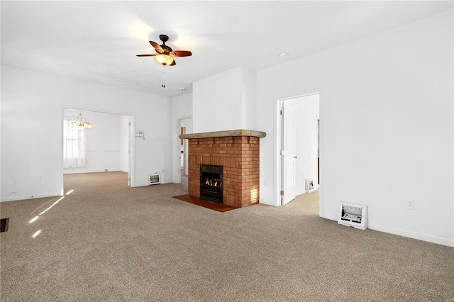 unfurnished living room featuring ceiling fan with notable chandelier, carpet floors, and a brick fireplace