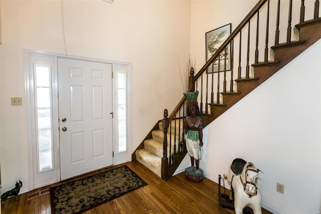 foyer entrance with dark hardwood / wood-style floors