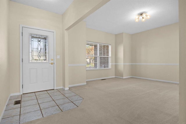 entrance foyer with light carpet