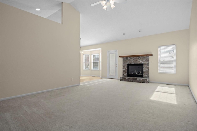 unfurnished living room with light carpet, a fireplace, ceiling fan, and vaulted ceiling