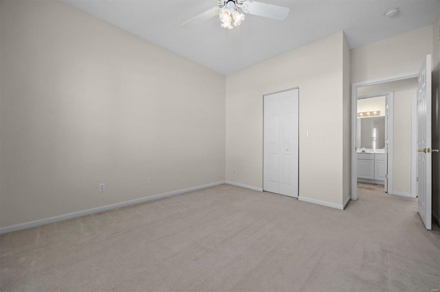 unfurnished bedroom with a closet, light colored carpet, and ceiling fan