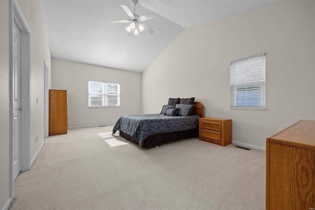 bedroom with light colored carpet, vaulted ceiling, and ceiling fan