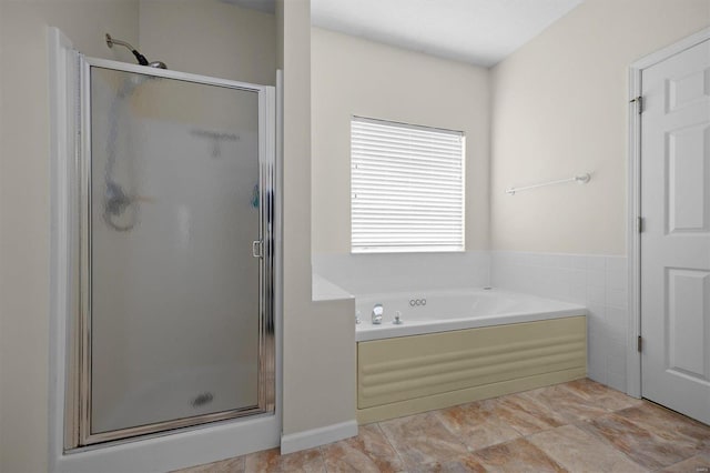 bathroom with shower with separate bathtub