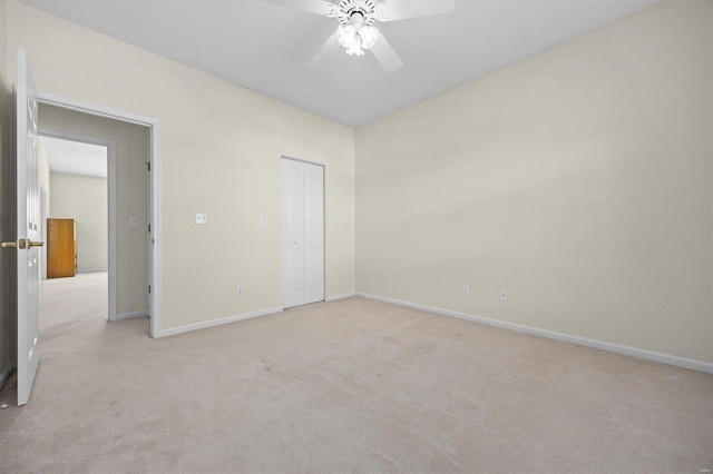 unfurnished bedroom with ceiling fan, a closet, and light colored carpet