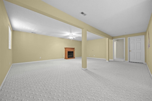 basement with carpet floors and a textured ceiling