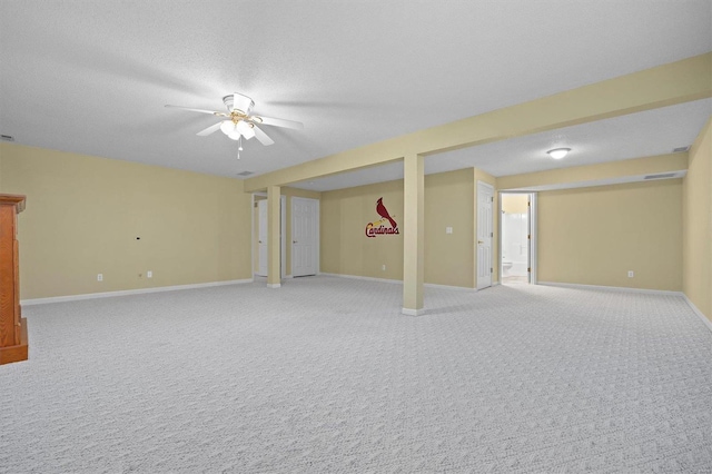 unfurnished room with carpet flooring, ceiling fan, and a textured ceiling