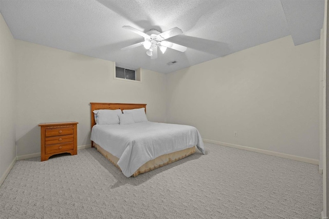 carpeted bedroom with a textured ceiling and ceiling fan