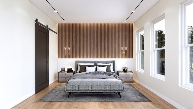 bedroom featuring light hardwood / wood-style floors and a barn door