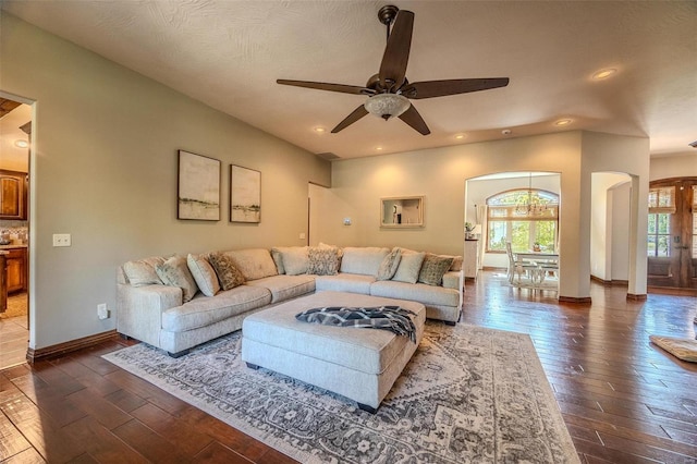 living room featuring a textured ceiling, dark wood-type flooring, ceiling fan, and french doors