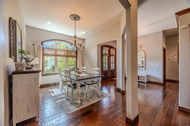 dining area featuring a notable chandelier and dark hardwood / wood-style floors