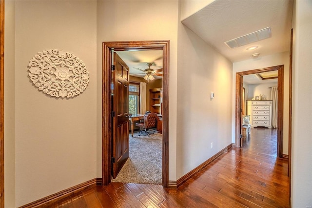 corridor with dark hardwood / wood-style floors