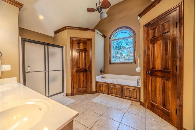 bathroom with lofted ceiling, independent shower and bath, tile patterned floors, ceiling fan, and vanity