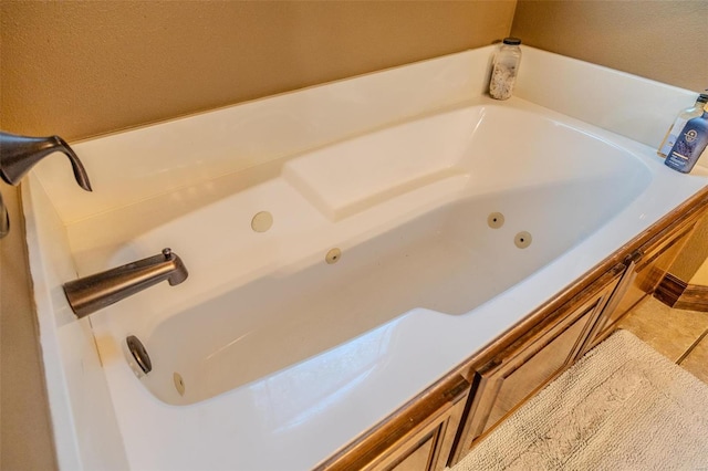 bathroom featuring tile patterned flooring and a bath