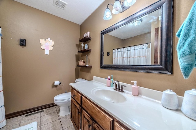 bathroom featuring a textured ceiling, vanity, toilet, and tile patterned floors