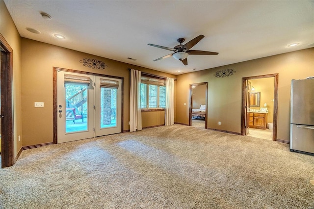 interior space with ceiling fan and light carpet