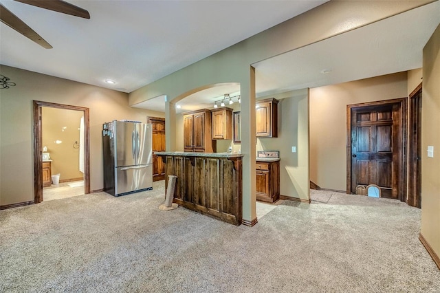 kitchen with stainless steel fridge, ceiling fan, and light carpet