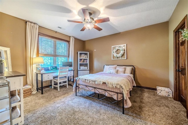 bedroom featuring a textured ceiling, carpet, and ceiling fan