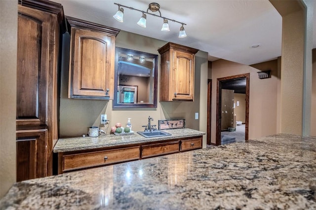 kitchen featuring rail lighting and sink