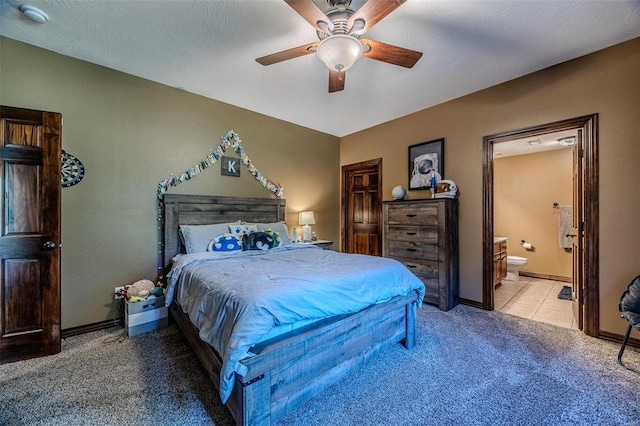 carpeted bedroom with a textured ceiling, ceiling fan, and ensuite bathroom