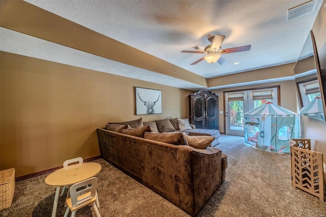 carpeted living room featuring ceiling fan and french doors