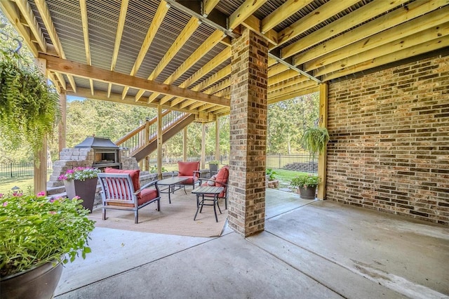 view of patio featuring an outdoor living space with a fireplace