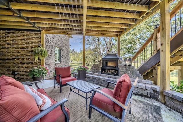 view of patio featuring an outdoor living space with a fireplace