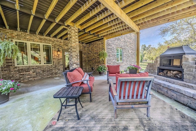 view of patio featuring an outdoor living space with a fireplace