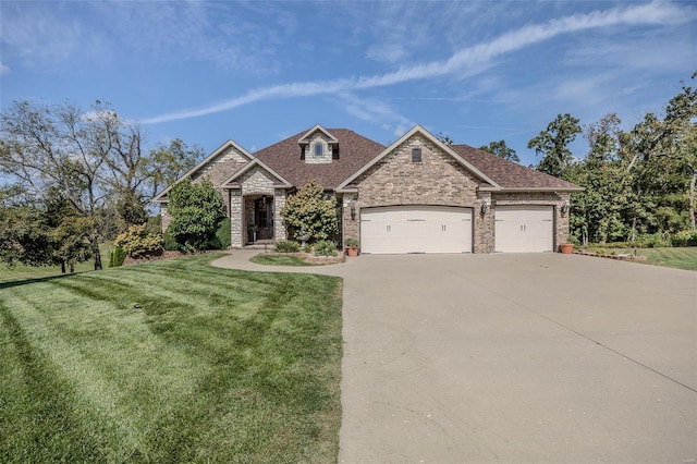 view of front of house featuring a garage and a front lawn