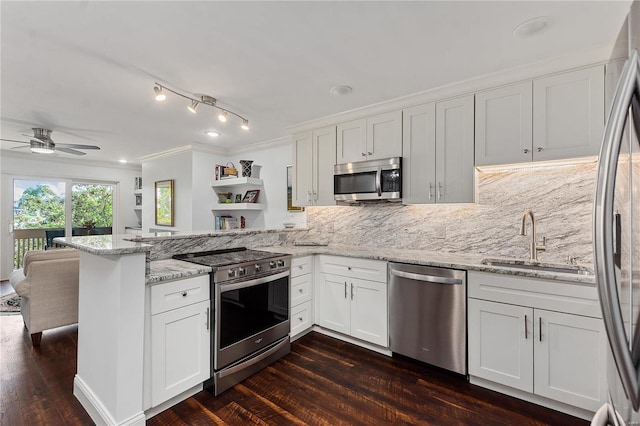 kitchen featuring kitchen peninsula, white cabinetry, dark wood-type flooring, and stainless steel appliances