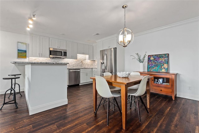 dining space featuring ornamental molding, a notable chandelier, and dark wood-type flooring