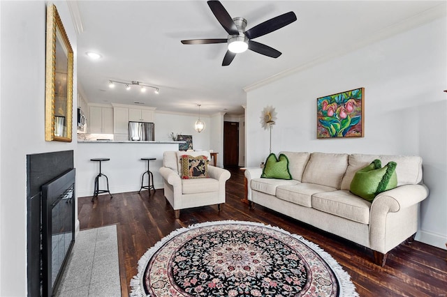 living room featuring ornamental molding, dark hardwood / wood-style flooring, and ceiling fan