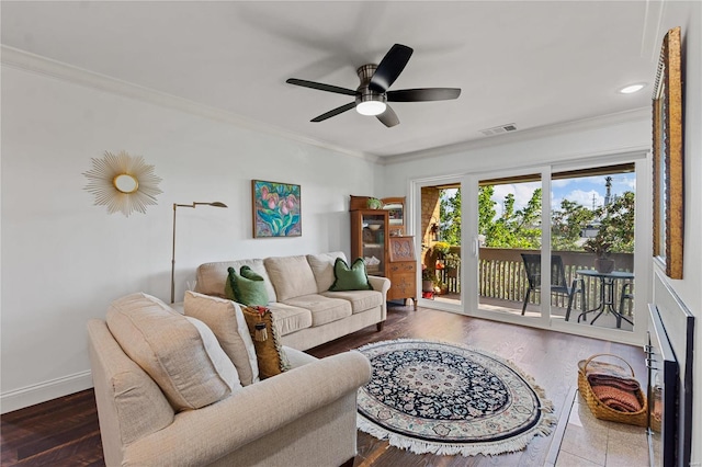 living room with ceiling fan, ornamental molding, and dark hardwood / wood-style flooring