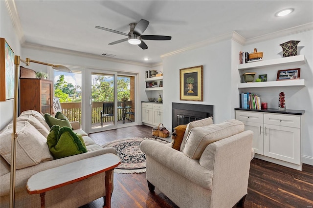 living room with ornamental molding, dark wood-type flooring, and ceiling fan