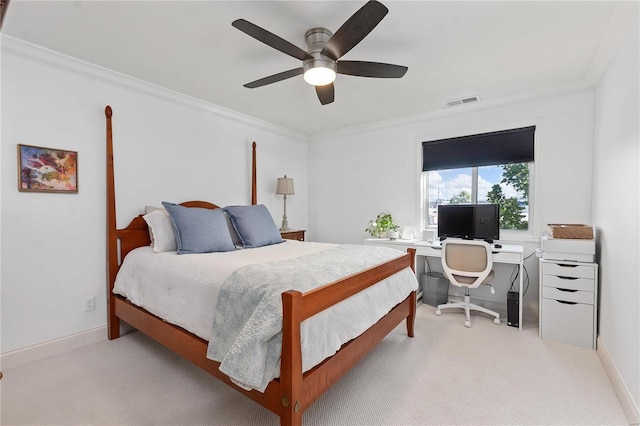 carpeted bedroom with ceiling fan and ornamental molding