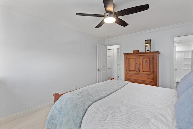 carpeted bedroom with connected bathroom, ceiling fan, and crown molding