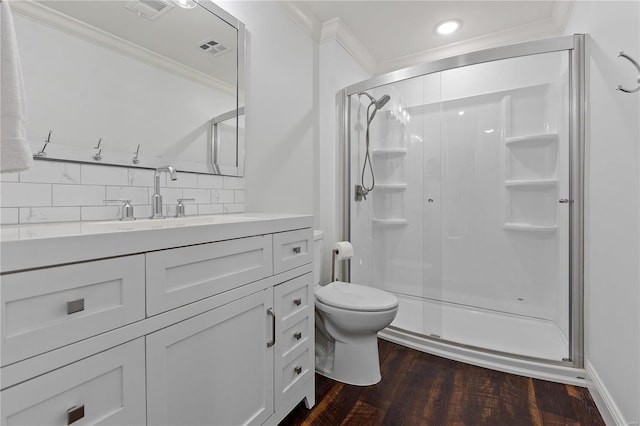 bathroom featuring a shower with shower door, backsplash, vanity, toilet, and hardwood / wood-style floors