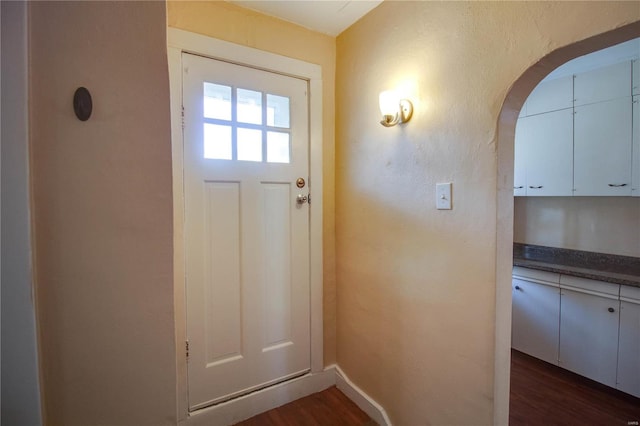 doorway with dark wood-type flooring