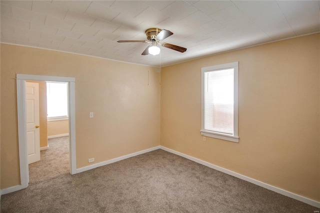 carpeted empty room featuring ceiling fan