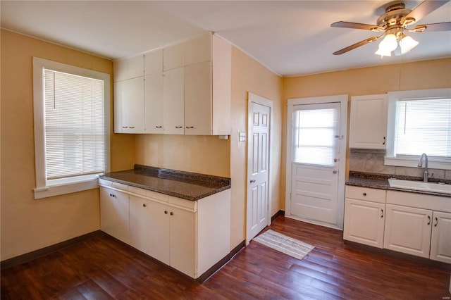 kitchen featuring white cabinetry, dark hardwood / wood-style flooring, sink, and ceiling fan