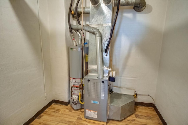 utility room featuring gas water heater