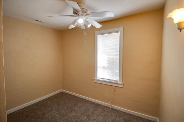 carpeted spare room with ceiling fan