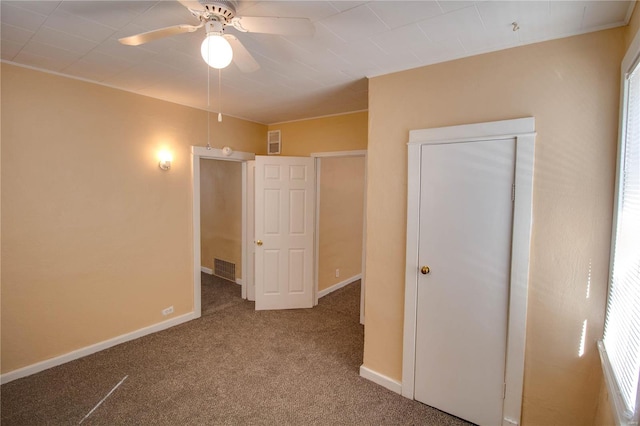 unfurnished bedroom with a closet, ceiling fan, and carpet flooring