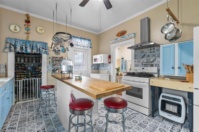 kitchen with heating unit, wood counters, island exhaust hood, white appliances, and blue cabinetry