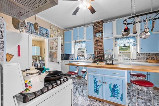 kitchen with blue cabinets, ceiling fan, white appliances, decorative backsplash, and butcher block counters