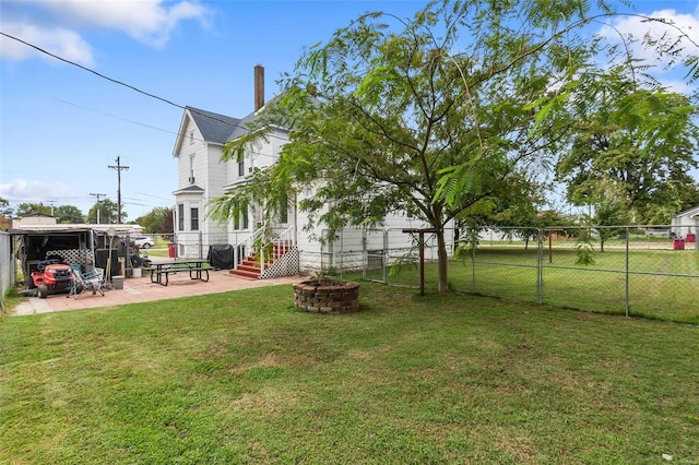 view of yard with a patio and an outdoor fire pit