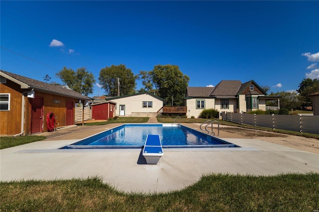 view of pool featuring a diving board