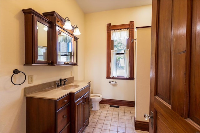 bathroom with vanity, tile patterned flooring, and toilet